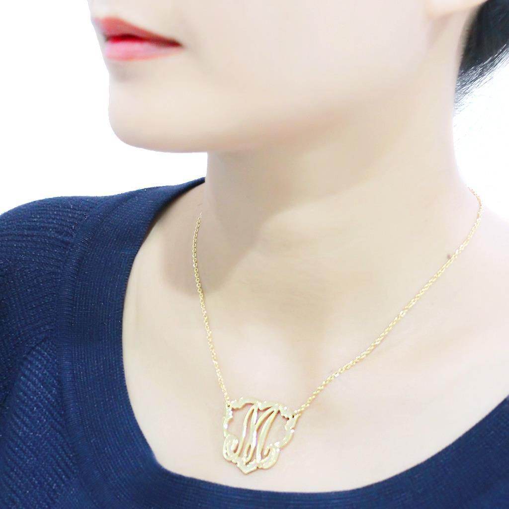 Personalized gold letter necklace showcased on a model wearing a blue top