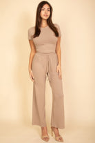 Beige women's outfit set ideal for summer travel clothes for women with a fitted top and wide-leg pants