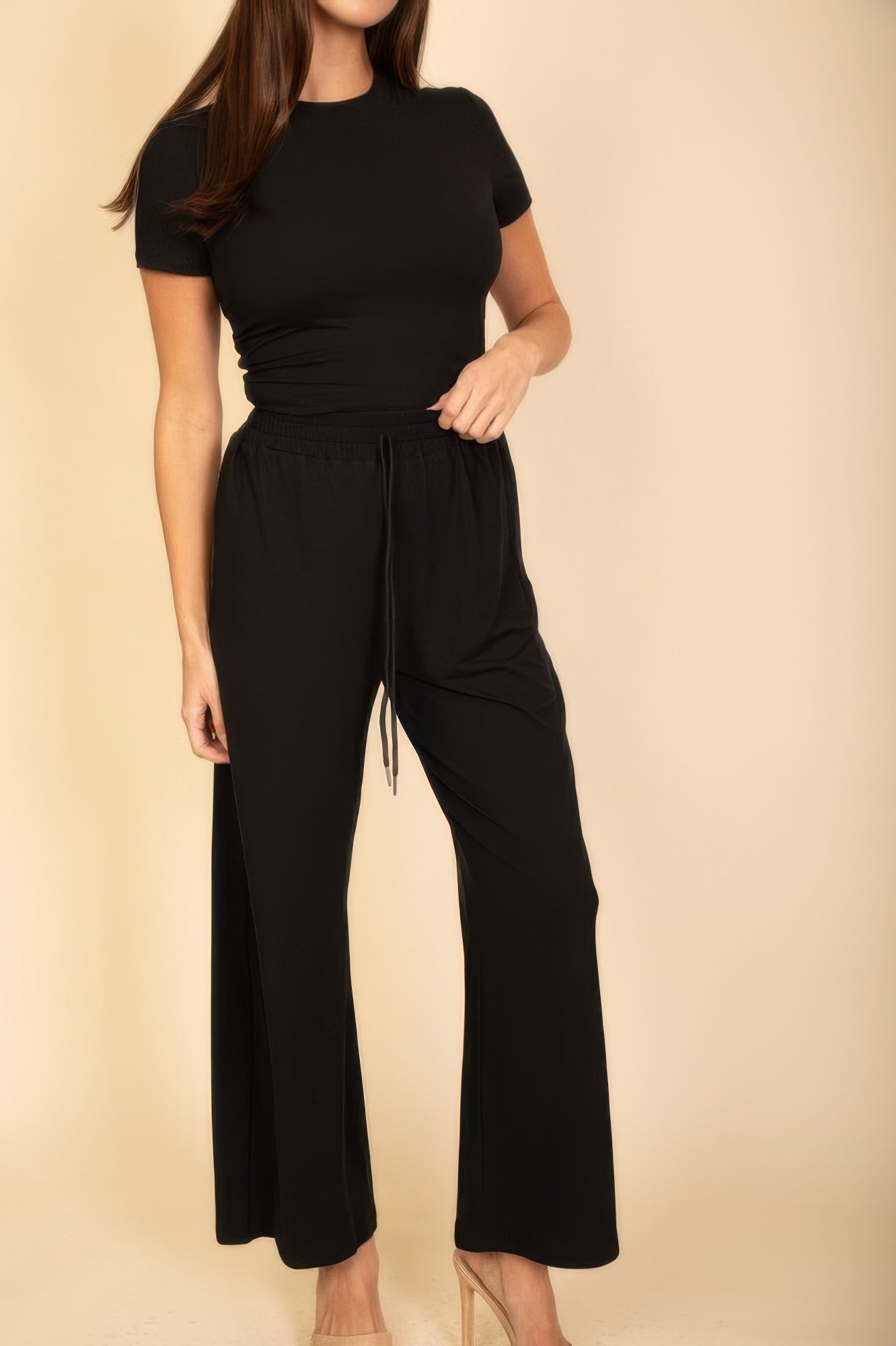 Chic black jumpsuit from VacationGrabs, perfect summer travel clothes for women, featuring a fitted top and flowing pants