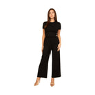 Elegant black two-piece outfit showcasing summer travel clothes for women with a stylish top and wide-leg pants