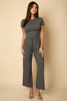 Gray women's outfit set with a fitted top and wide-leg pants, perfect summer travel clothes for women