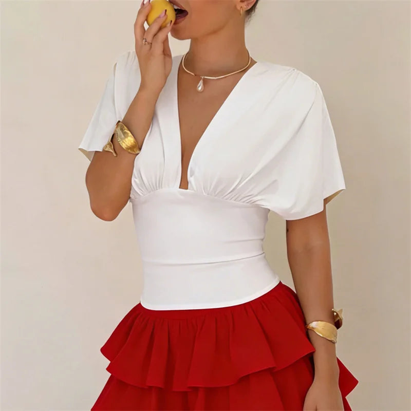 Women's white fitted top with flutter sleeves, perfect for summer outings