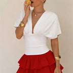 Women's white fitted top with flutter sleeves, perfect for summer outings