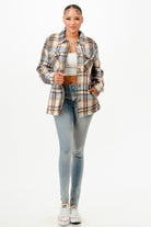 Stylish warm flannel jacket for women in plaid pattern paired with light jeans for a trendy look