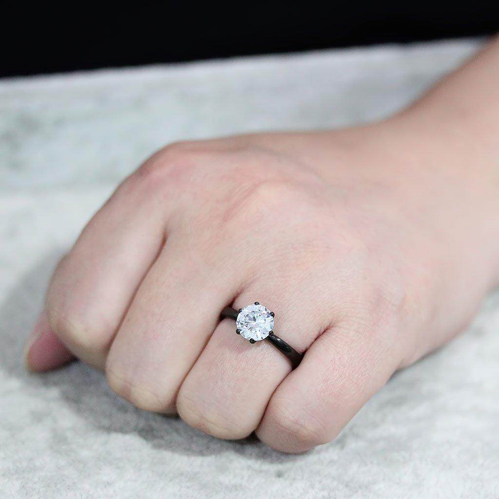 Womens black stainless steel ring featuring a sparkling round gemstone on a sleek band