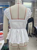 Women's white peplum blouse made from lightweight cotton, perfect for casual outings