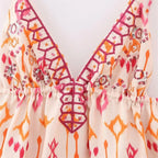 Women's boho top in orange and pink with embroidered details