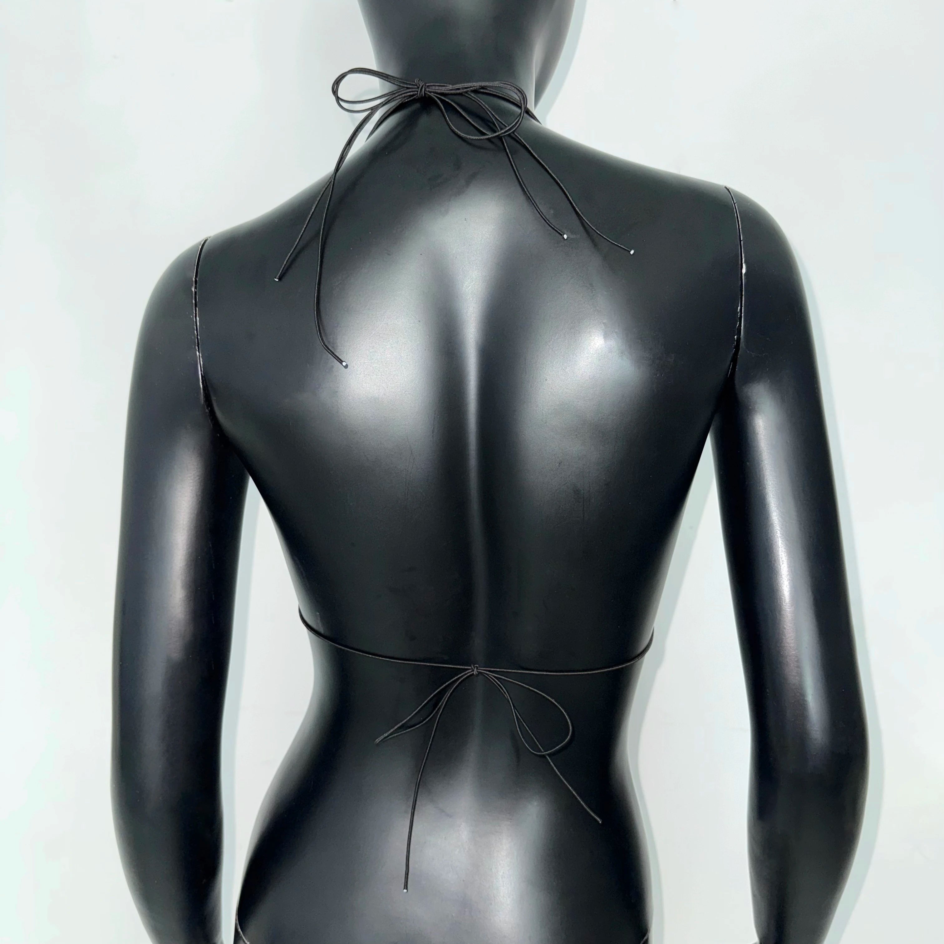 Back view of a sleek black bikini top, perfect for beach days