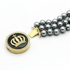 Stylish women's gold brass bracelet with crown design and gray pearl accents for elegant occasions