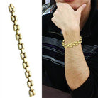 Men's model wearing a women's gold brass bracelet showcasing a stylish chain design