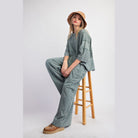 VacationGrabs womens loungewear travel pants in soft fabric worn with oversized top and bucket hat
