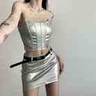Womens metallic skirt and crop top set in silver with a black belt worn by model