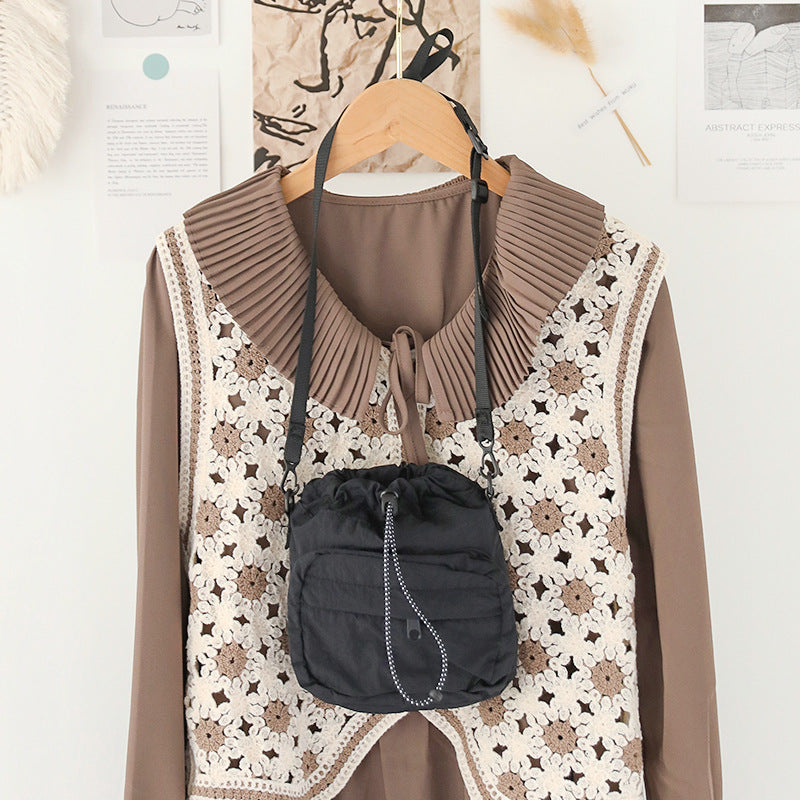 Stylish women's nylon drawstring bucket bag in black, perfect for casual outings.