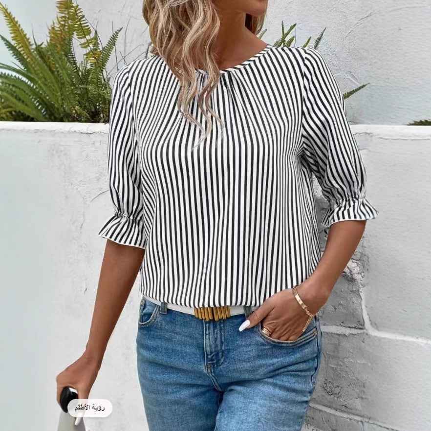 Women's striped blouse in black and white with a relaxed fit and rolled sleeves