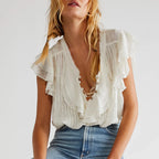 Women's white summer blouse top with ruffle details, perfect for casual outings