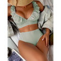 Women's striped green bathing suit, perfect for vacations and poolside relaxation