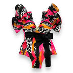 Colorful women's vacation bathing suits with bold prints and ruffled sleeves