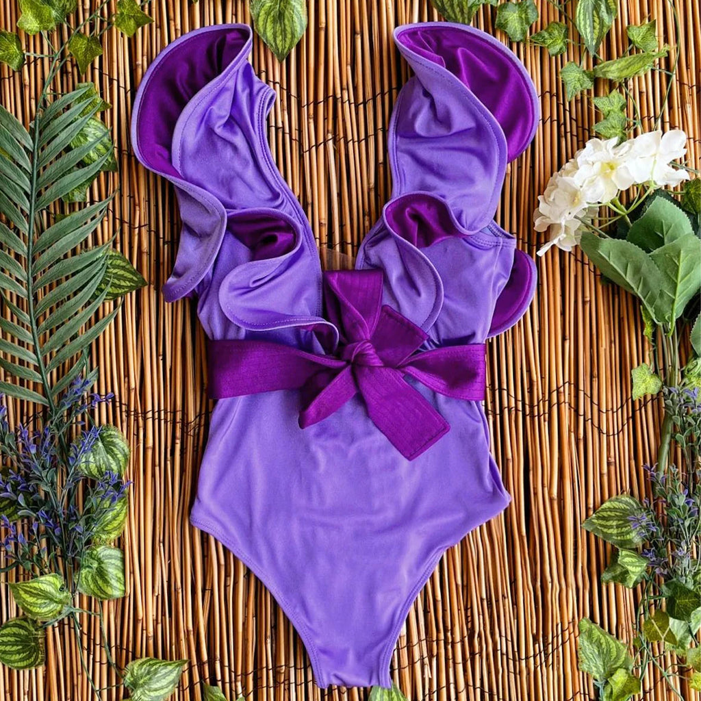 Purple women's vacation bathing suits with ruffled sleeves for beach days