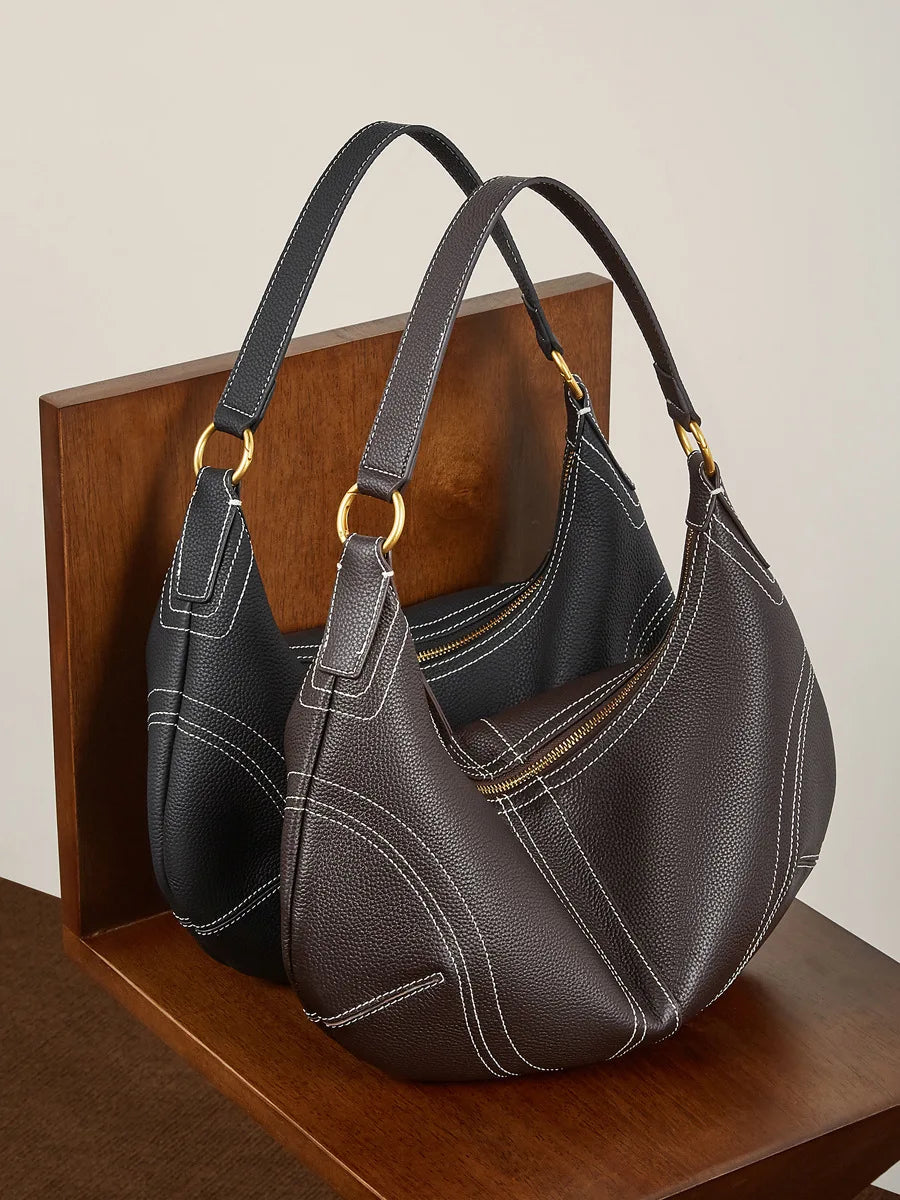 Two-tone leather crossbody mini bag with sleek design for everyday use.