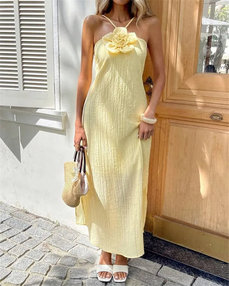 Women's yellow crinkle maxi dress with floral detail, perfect for summer outings