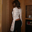 Women's white top with mesh detail, perfect for stylish layering