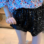 Women's floral top and black sequin shorts, vacation worthy clubwear