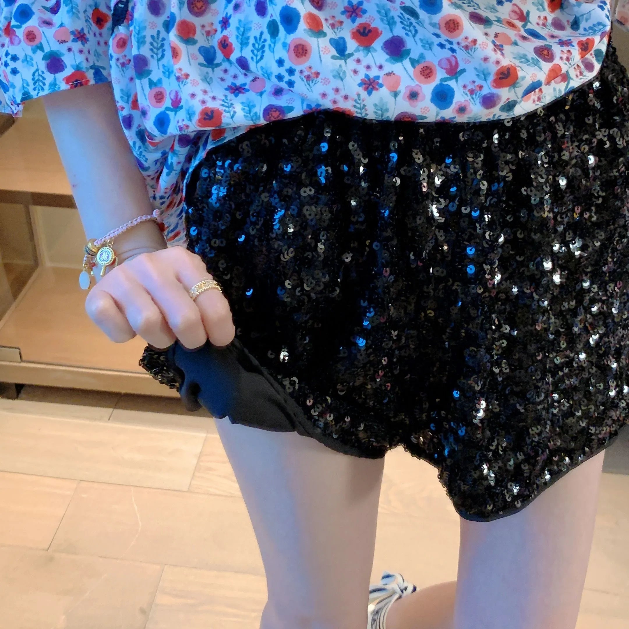 Women's floral top and black sequin shorts, vacation worthy clubwear
