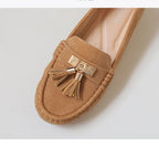 Women's tan suede loafers with gold tassel detail, vacation worthy
