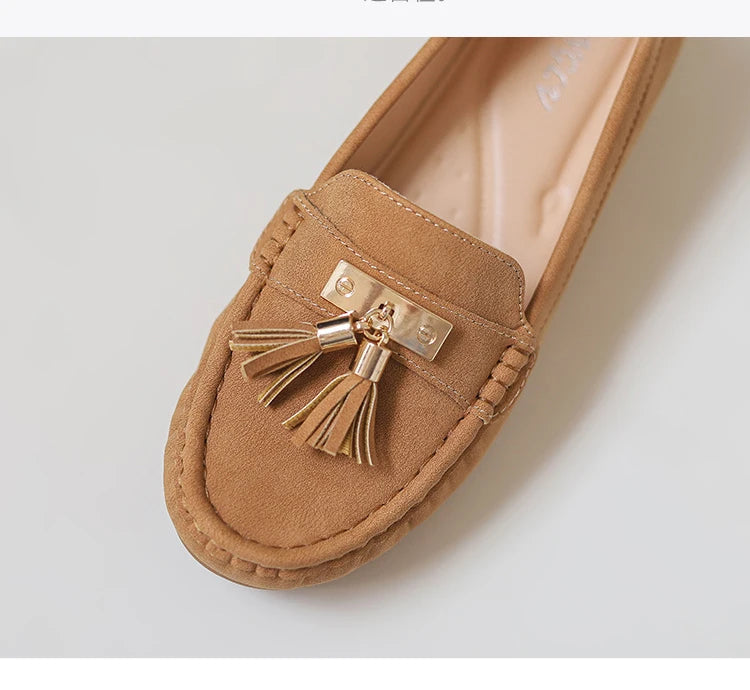 Women's tan suede loafers with gold tassel detail, vacation worthy