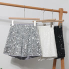 Women's vacation worthy sequin clubwear shorts in silver, white, and black