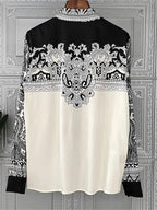 Women's black and white patterned blouse, perfect for stylish casual wear