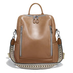 Tan leather travel bag with adjustable strap and dual zip pockets