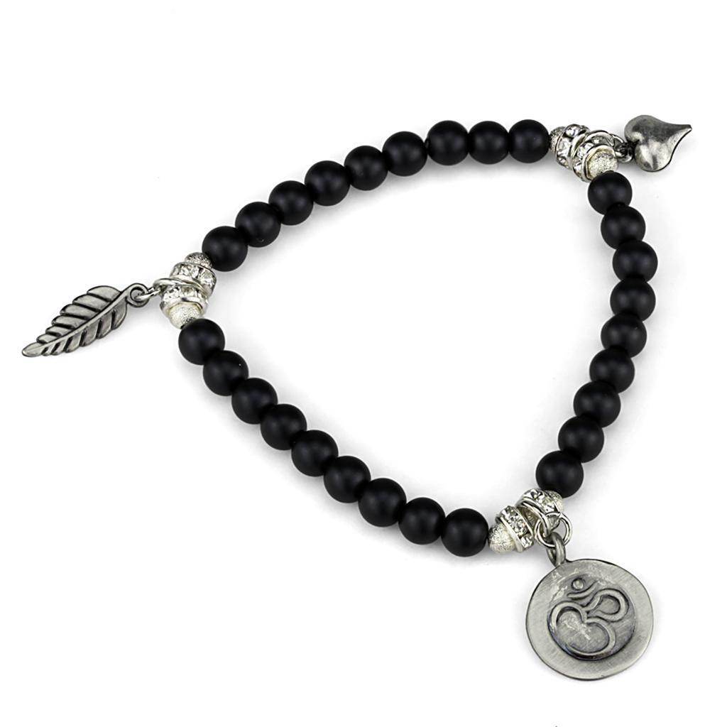 Antique silver brass bracelet for women featuring black beads and decorative charms