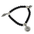 Antique silver brass bracelet for women featuring black beads and decorative charms
