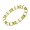Unique antique silver women's bracelet adorned with pearls and green gemstones