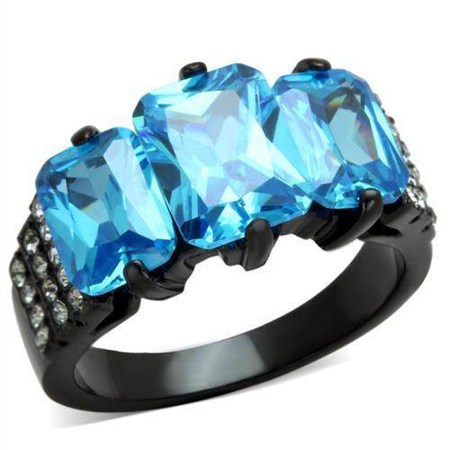 Stunning blue gemstone cocktail ring featuring three large blue stones with sparkling accents