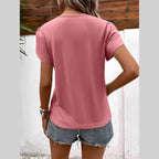 Back view of a pink casual v-neck vacation shirt for women, styled with denim shorts