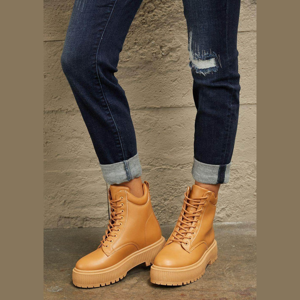 Women's tan combat boots in faux leather, perfect for casual outfits