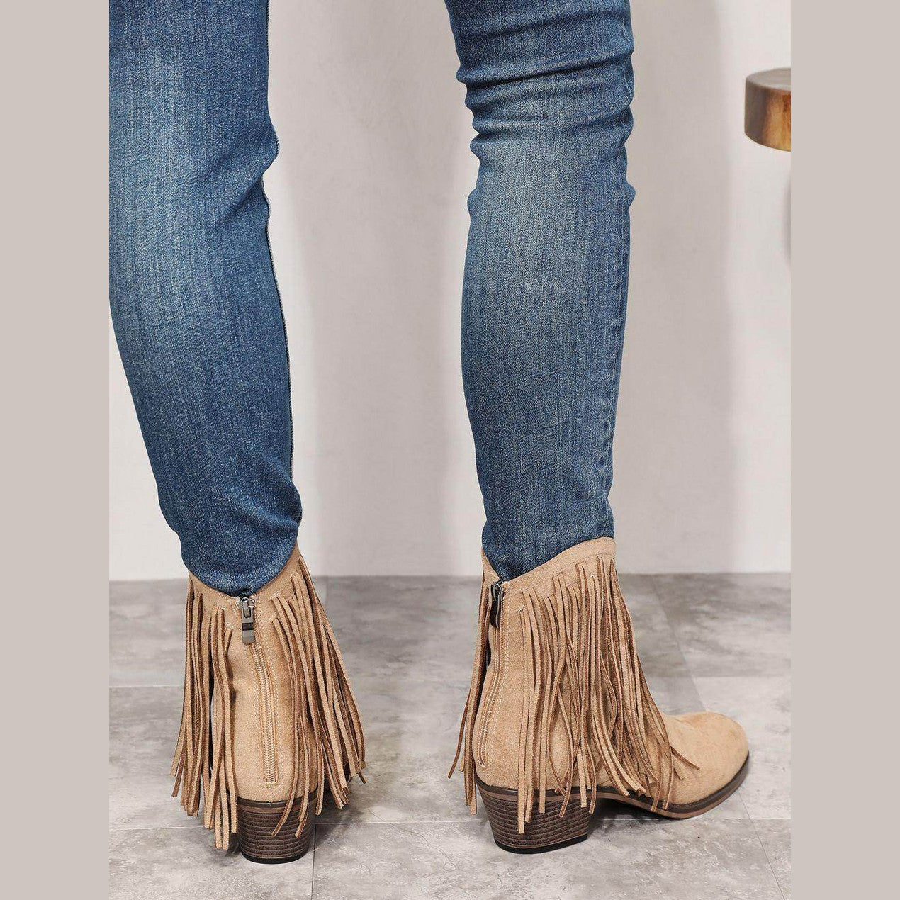 Women's beige cowboy boots with fringe detail, stylish for casual wear