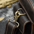 Detail of the metal clasp on the Crazy Horse leather camera bag, showcasing quality craftsmanship
