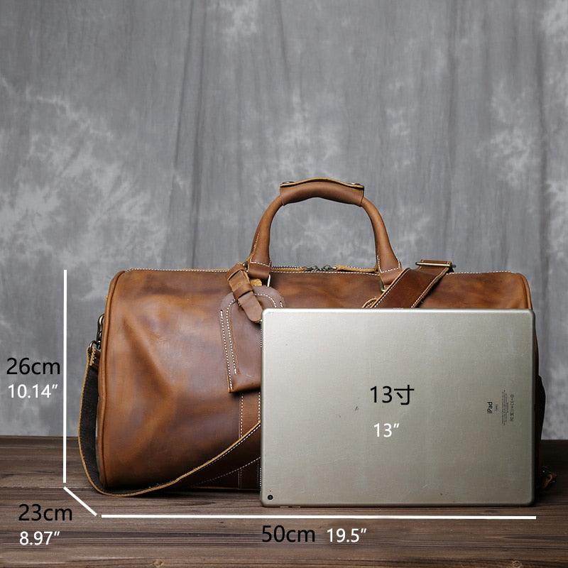 Crazy horse leather travel bag by VacationGrabs shown next to a 13-inch laptop for size comparison