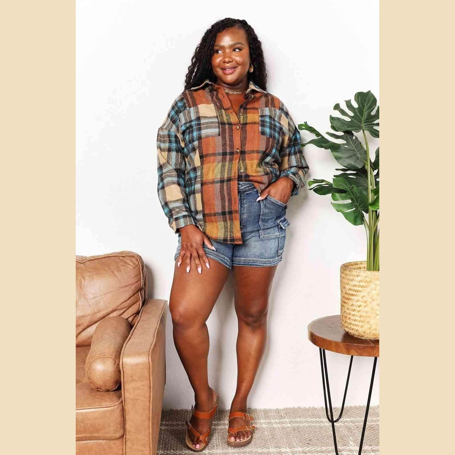 Trendsi women's curved hem plaid shacket in warm colors, styled with denim shorts and casual sandals
