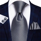 Stylish designer wedding ties for men in gray with a modern pattern and matching pocket square and cufflinks