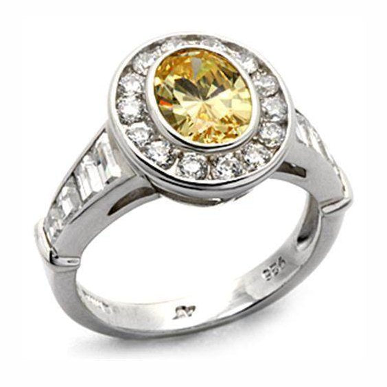 Elegant sterling silver cocktail ring featuring an oval yellow gemstone surrounded by sparkling gems
