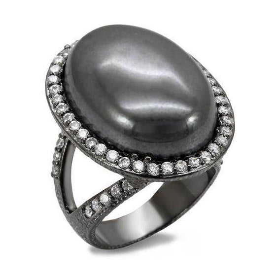Oval gemstone fashion ring with a dark stone and sparkling accents, perfect for elegant outings