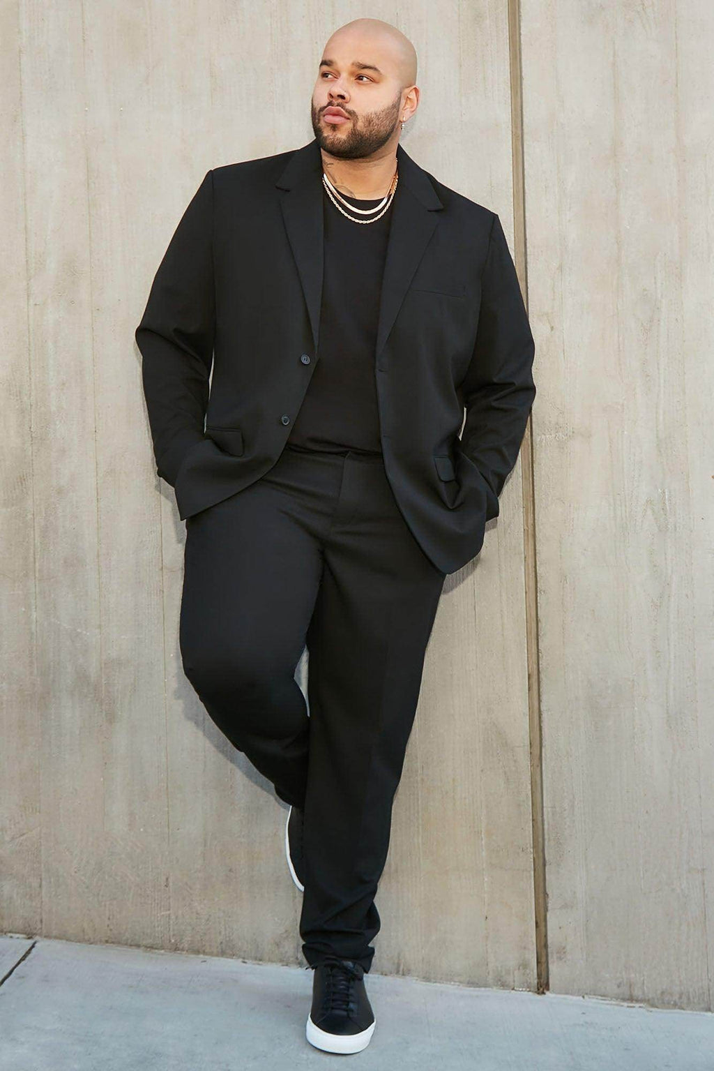 Fashion Nova men's modern stretch trousers in black, styled with a matching blazer for a sleek look