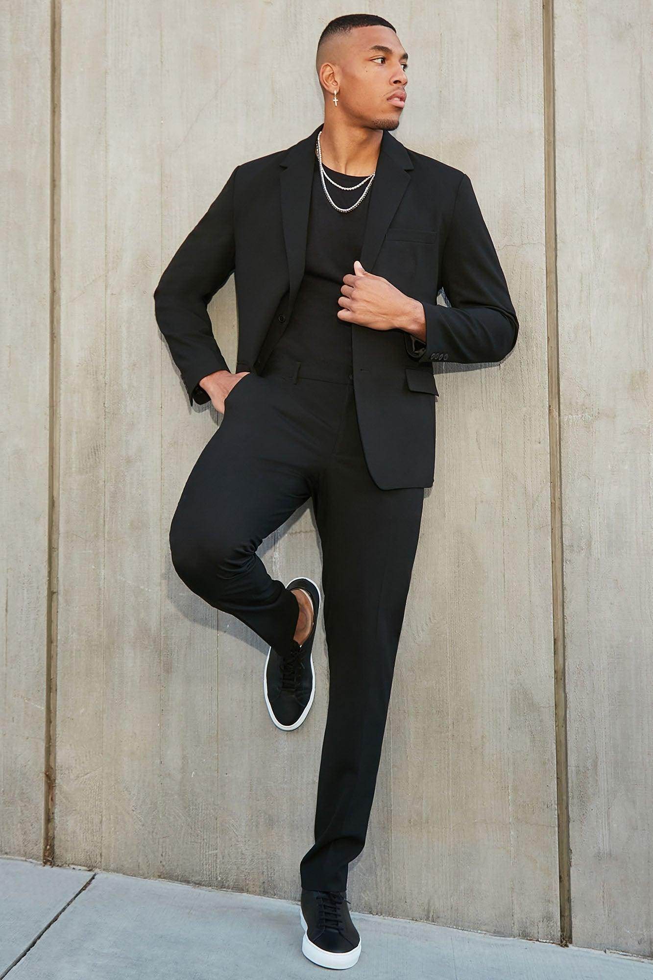 Fashion Nova modern stretch trousers in black styled with a matching blazer and sleek sneakers for a trendy look