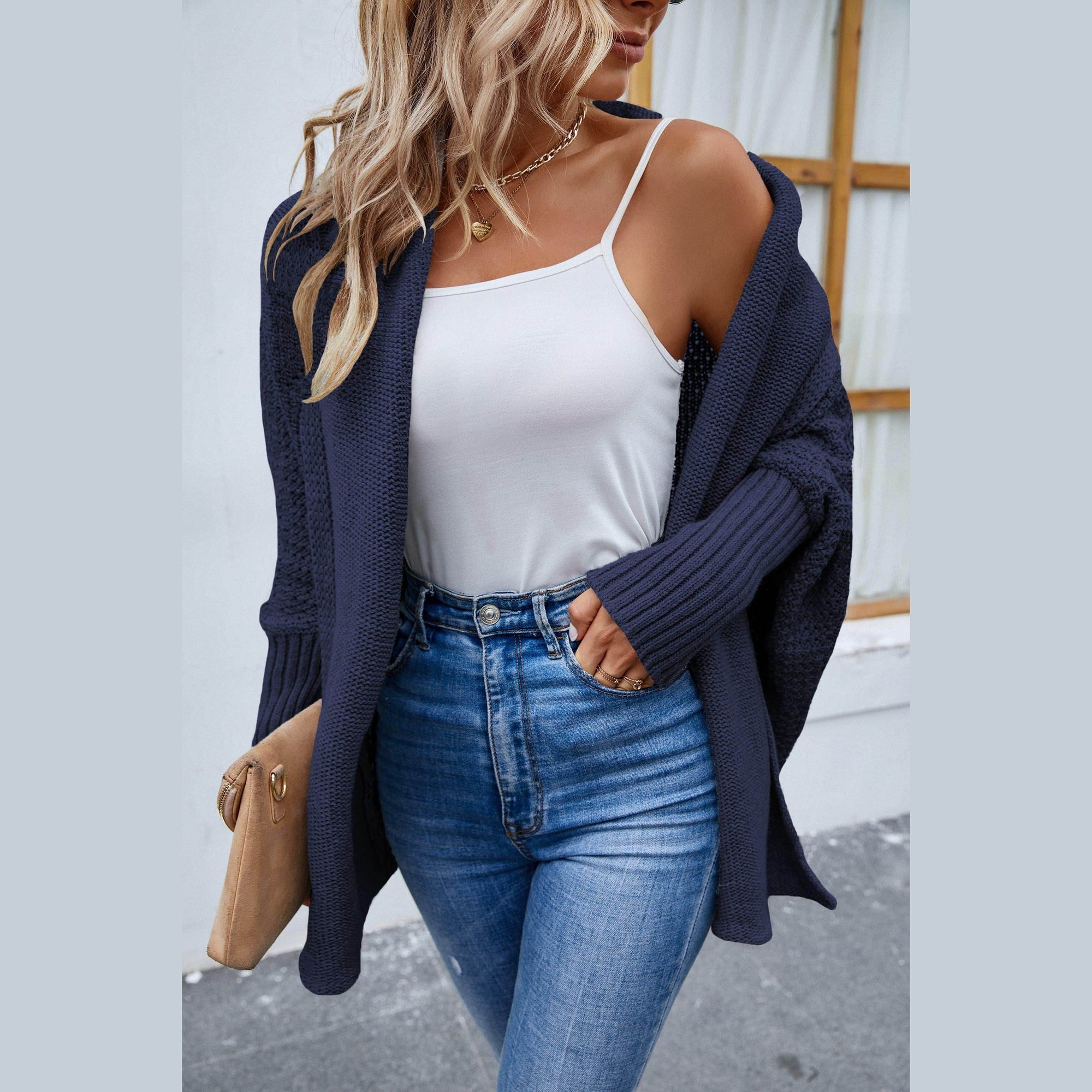 Trendsi stylish travel cardigan in navy worn over a white tank top and high-waisted jeans