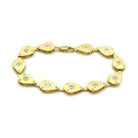 Gold bracelet with teardrop design and gemstones, perfect fashion vacation jewelry for women