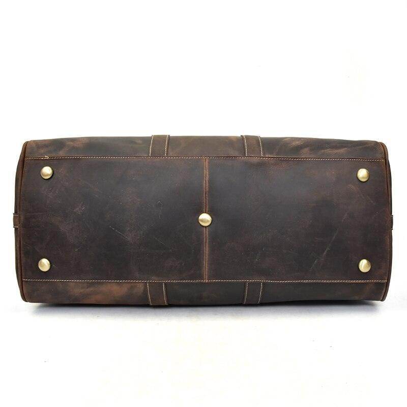 Bottom view of a genuine leather weekender bag with brass studs for durability and style
